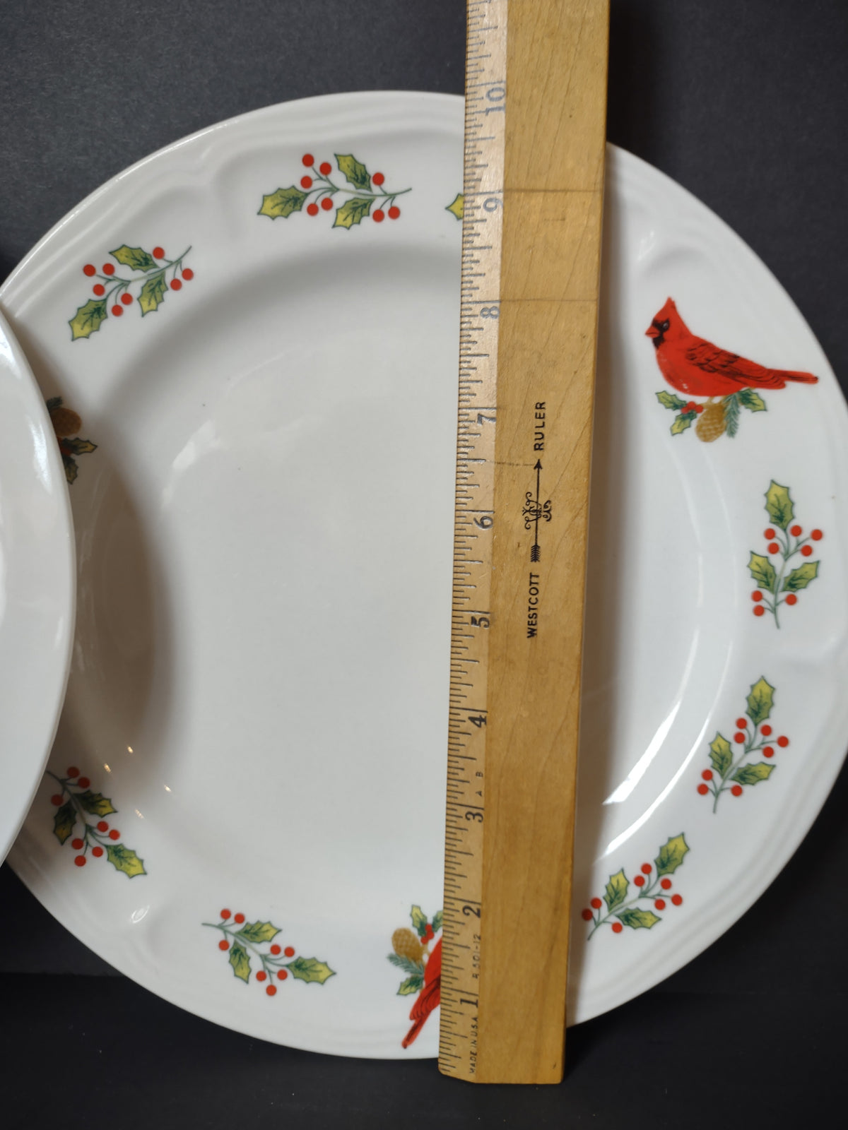 Gibson cardinal holly plate with ruler showing approximate diameter
