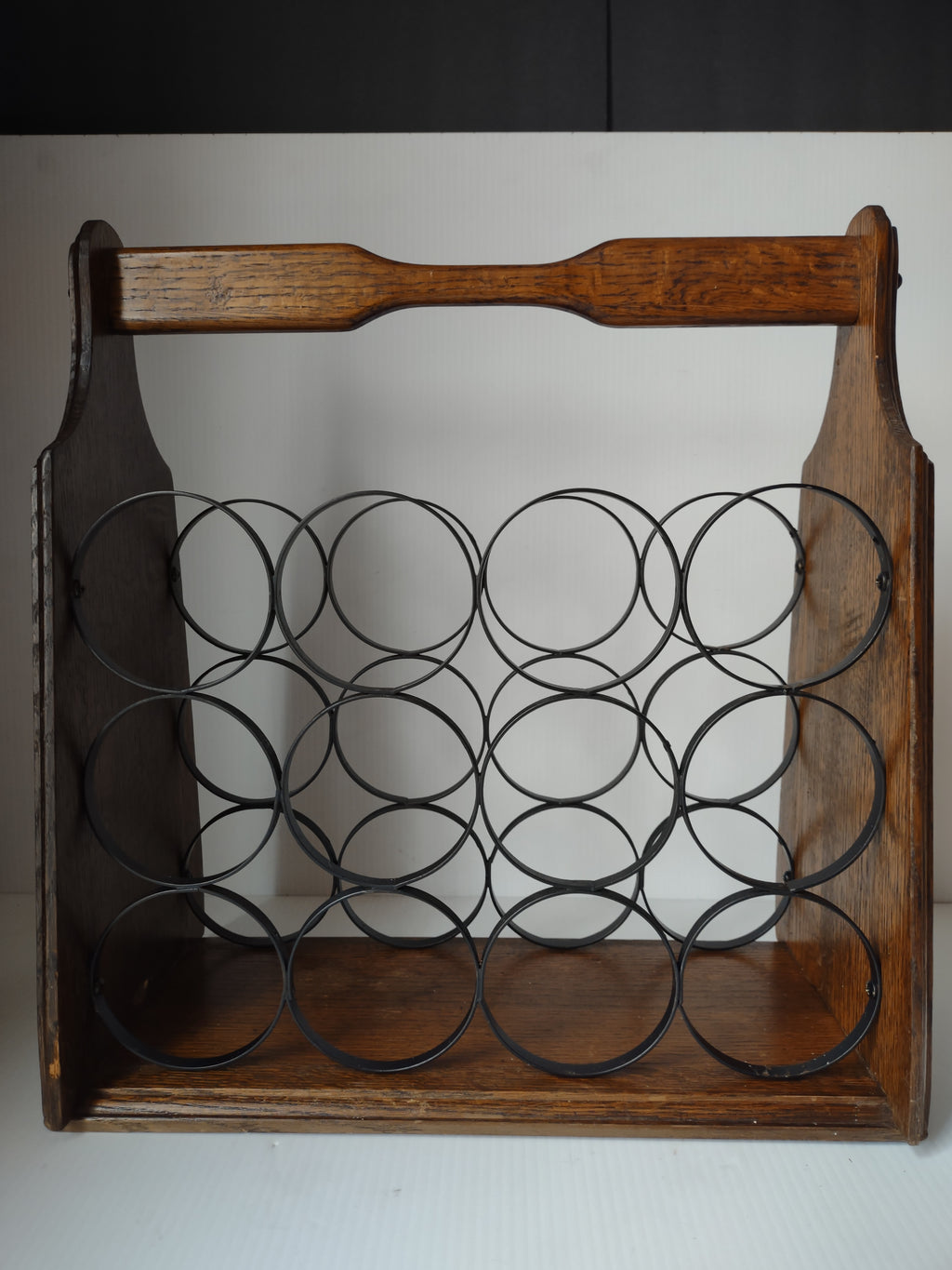 Vintage brown wood and black metal 12 bottle wine rack with top handle