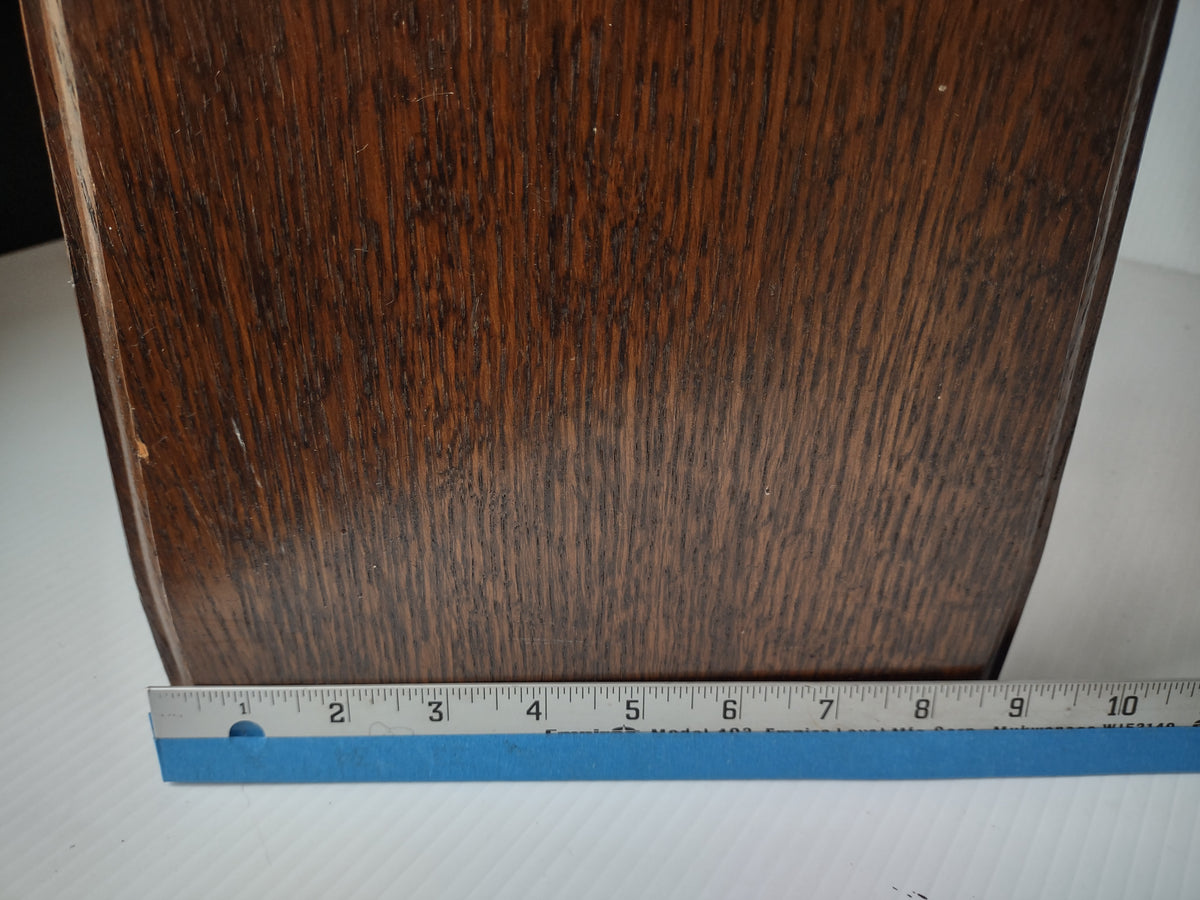 Wooden side of wine rack with depth ruler and visible surface wear