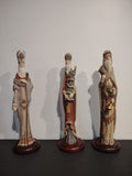 Three St. Nicholas and Me vintage Santa figurines on round bases