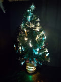 Vintage fiber optic Christmas tree shown illuminated with star topper and Merry Christmas base