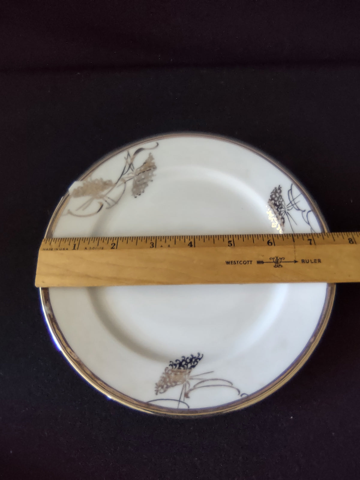 White glaze and gold floral rim detail