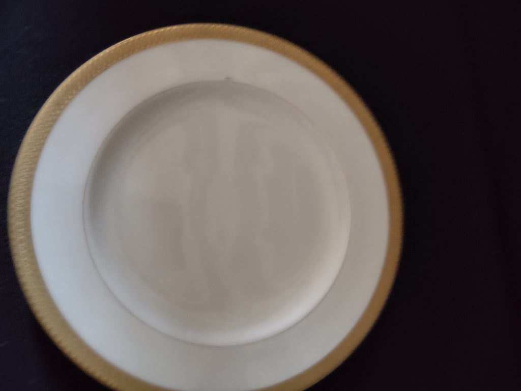 Front view of cream plate with gold border