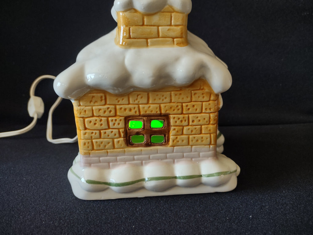 Front view of snowy Christmas cottage