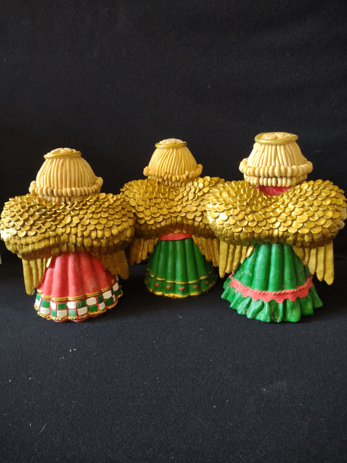Back view of angel figurines showing gold wings