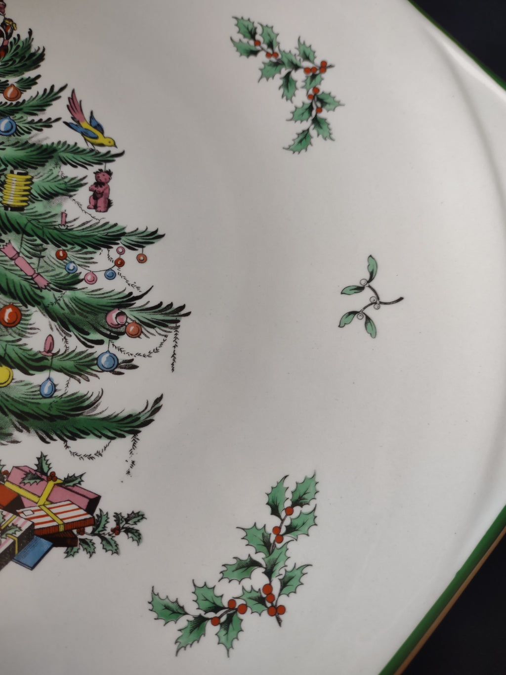 Close-up of Santa-topped Christmas tree and presents