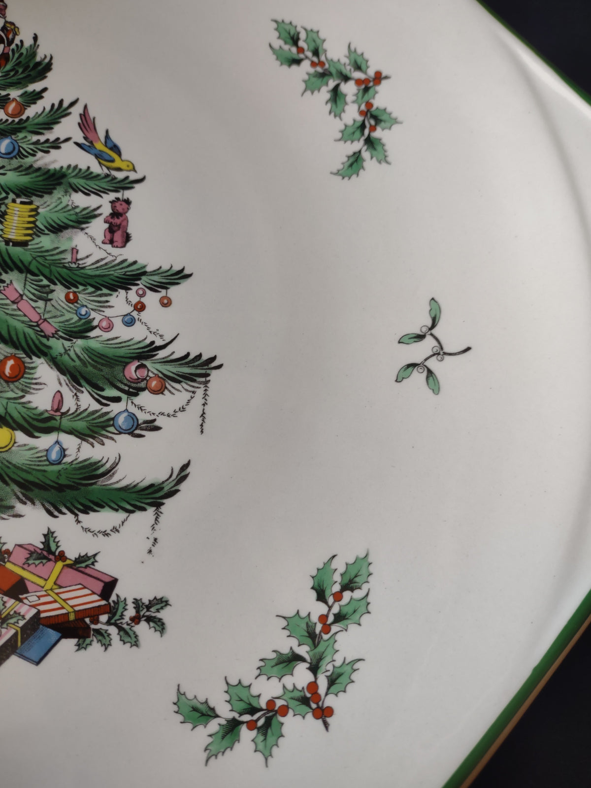 Close-up of Santa-topped Christmas tree and presents