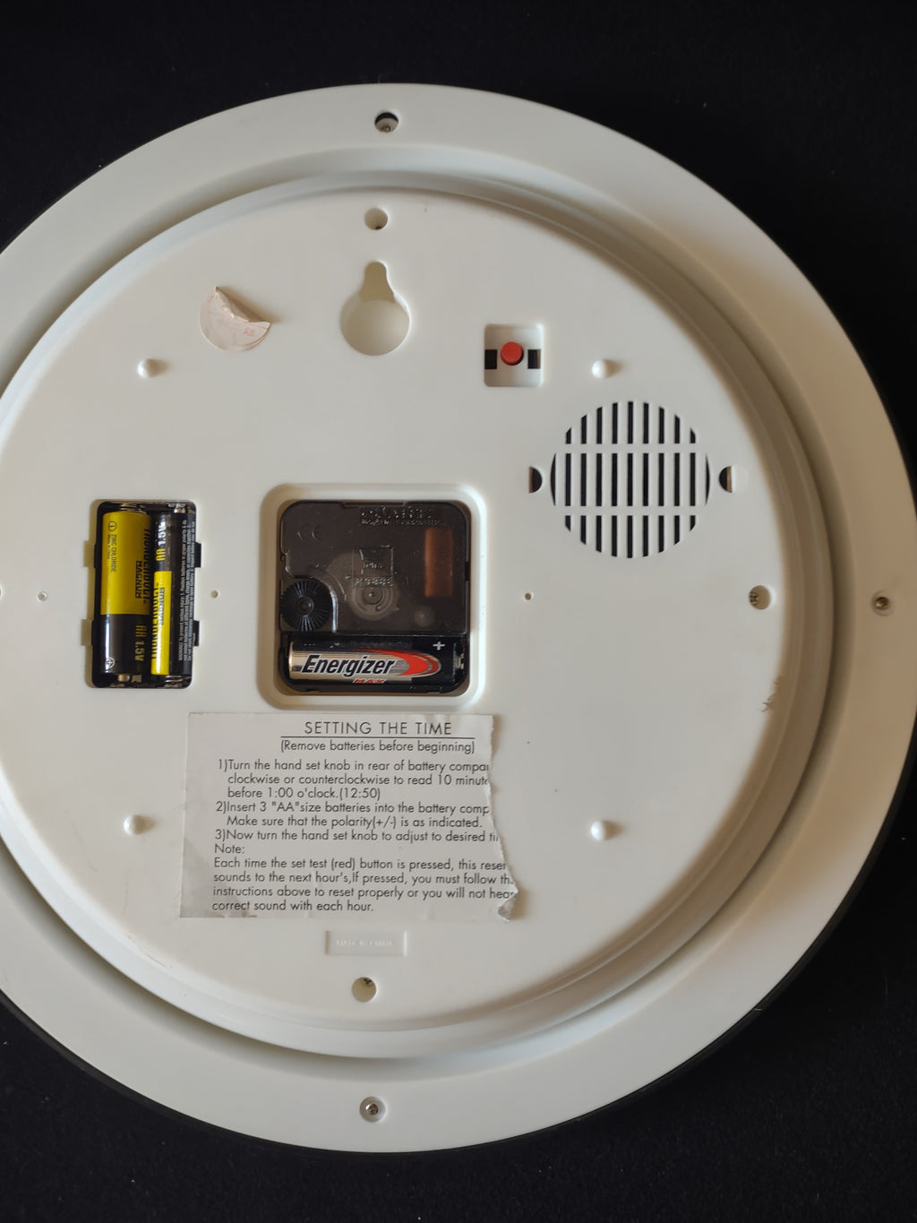Rear of Christmas wall clock showing battery compartments speaker and hanging opening