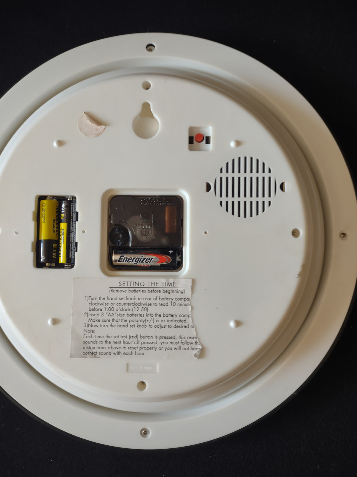 Rear of Christmas wall clock showing battery compartments speaker and hanging opening
