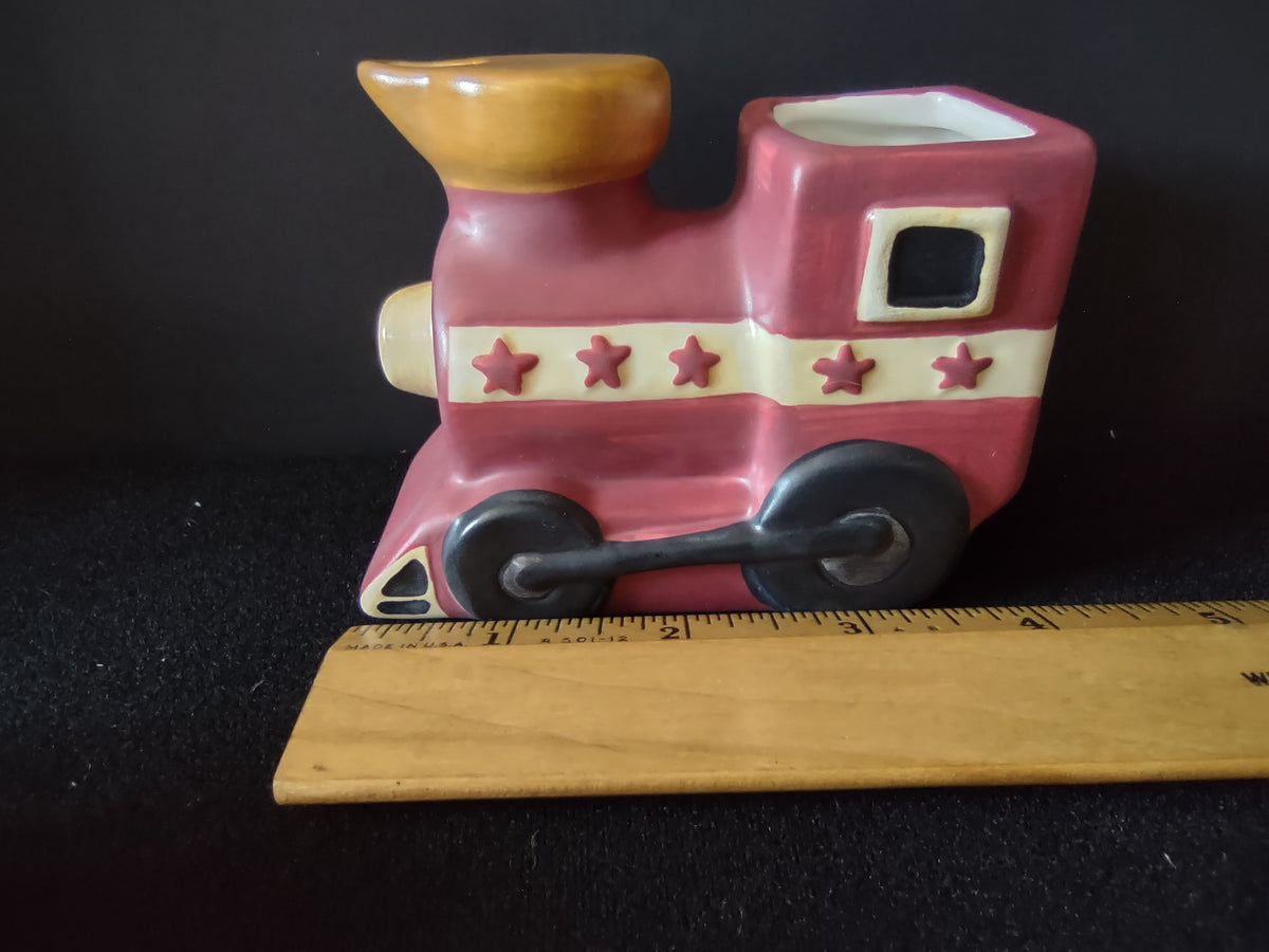 Train and drum beside height ruler