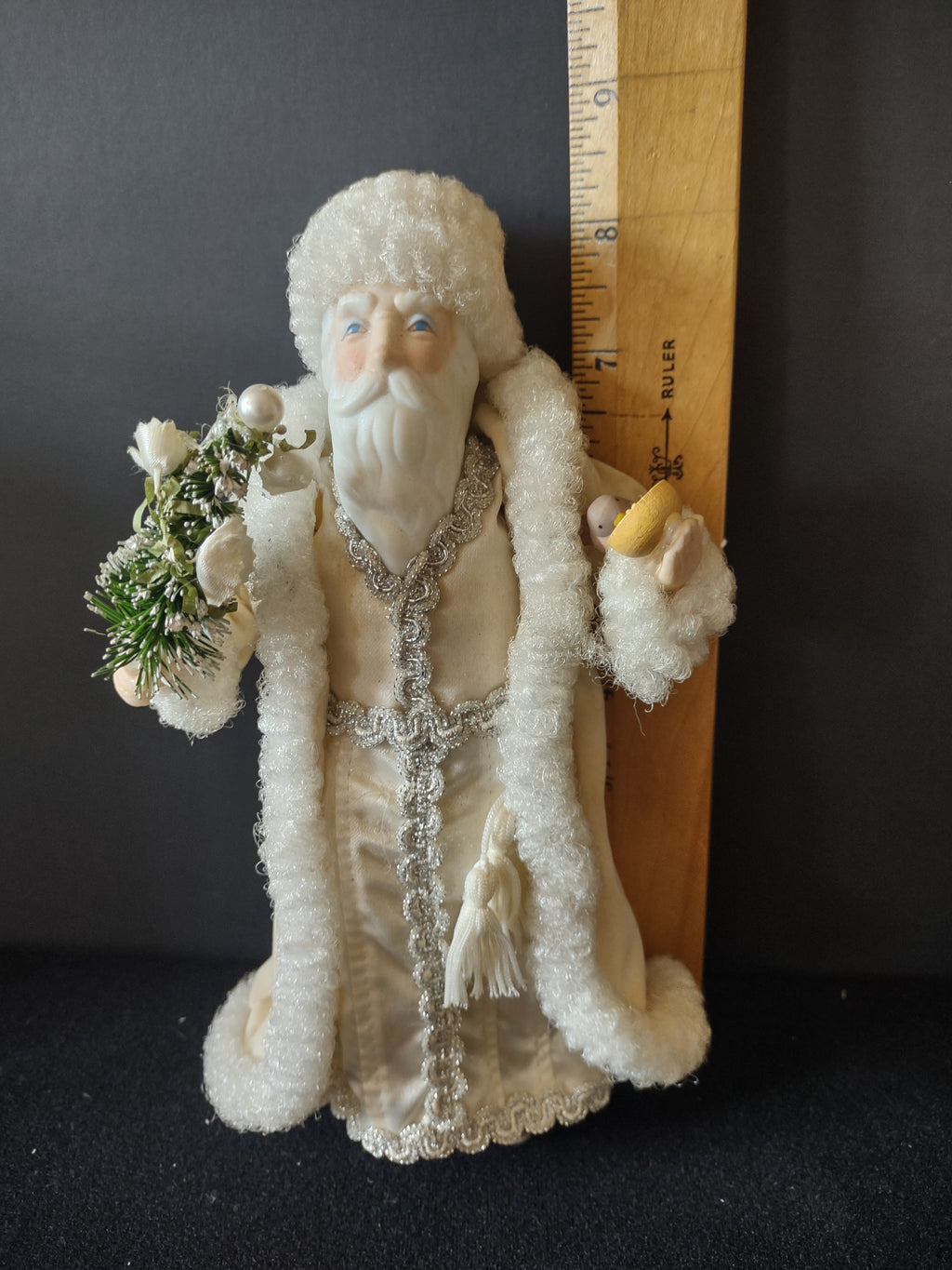 Santa ornament beside ruler