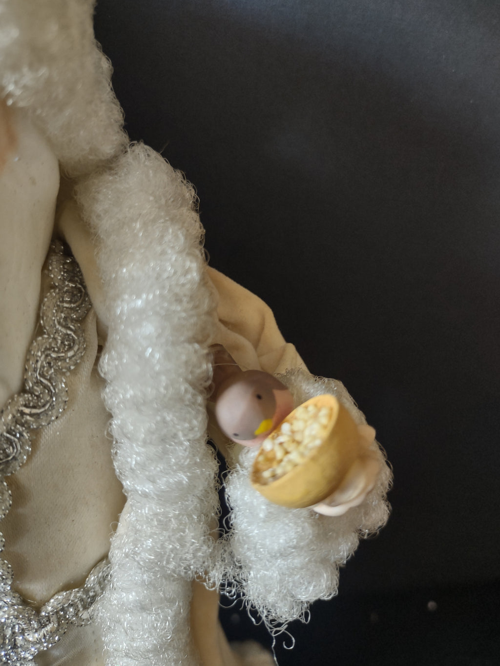 Small bird and golden-yellow bowl detail