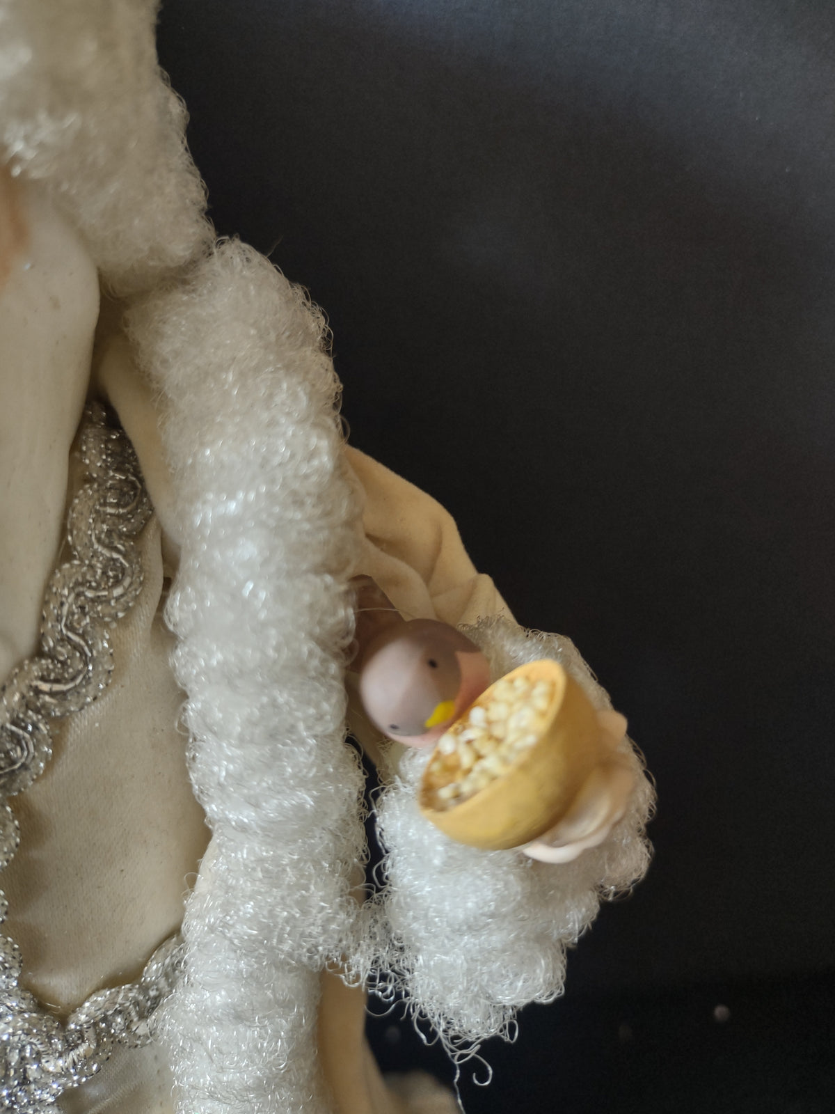 Small bird and golden-yellow bowl detail