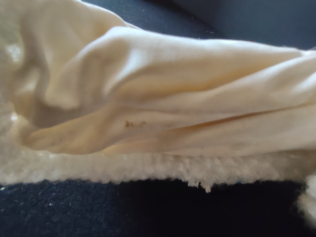 Close-up of discoloration on inner robe fabric