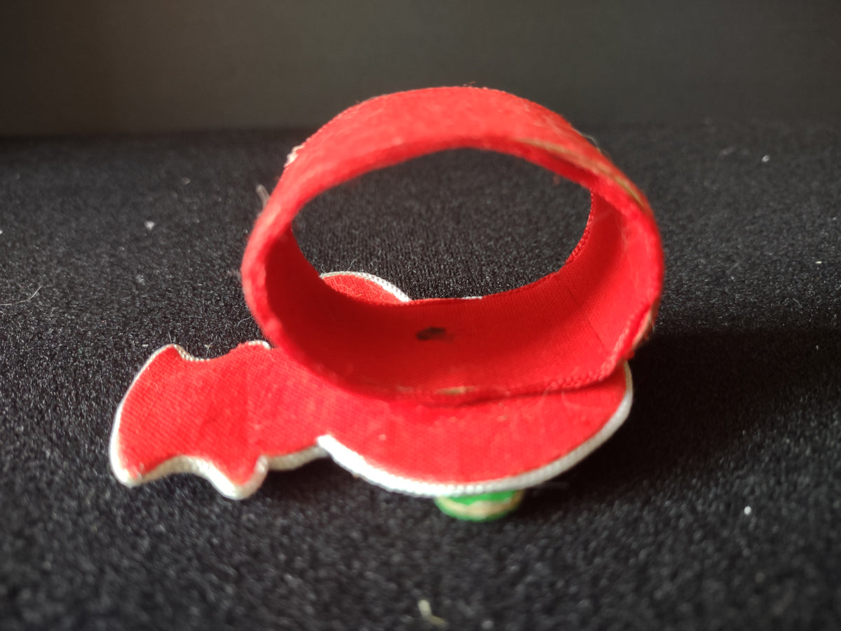 Red fabric ring backing showing age-related wear