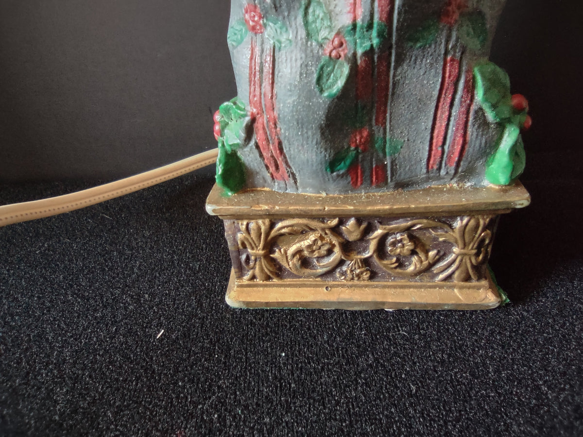 Ornate gold-tone lamp base with surface wear