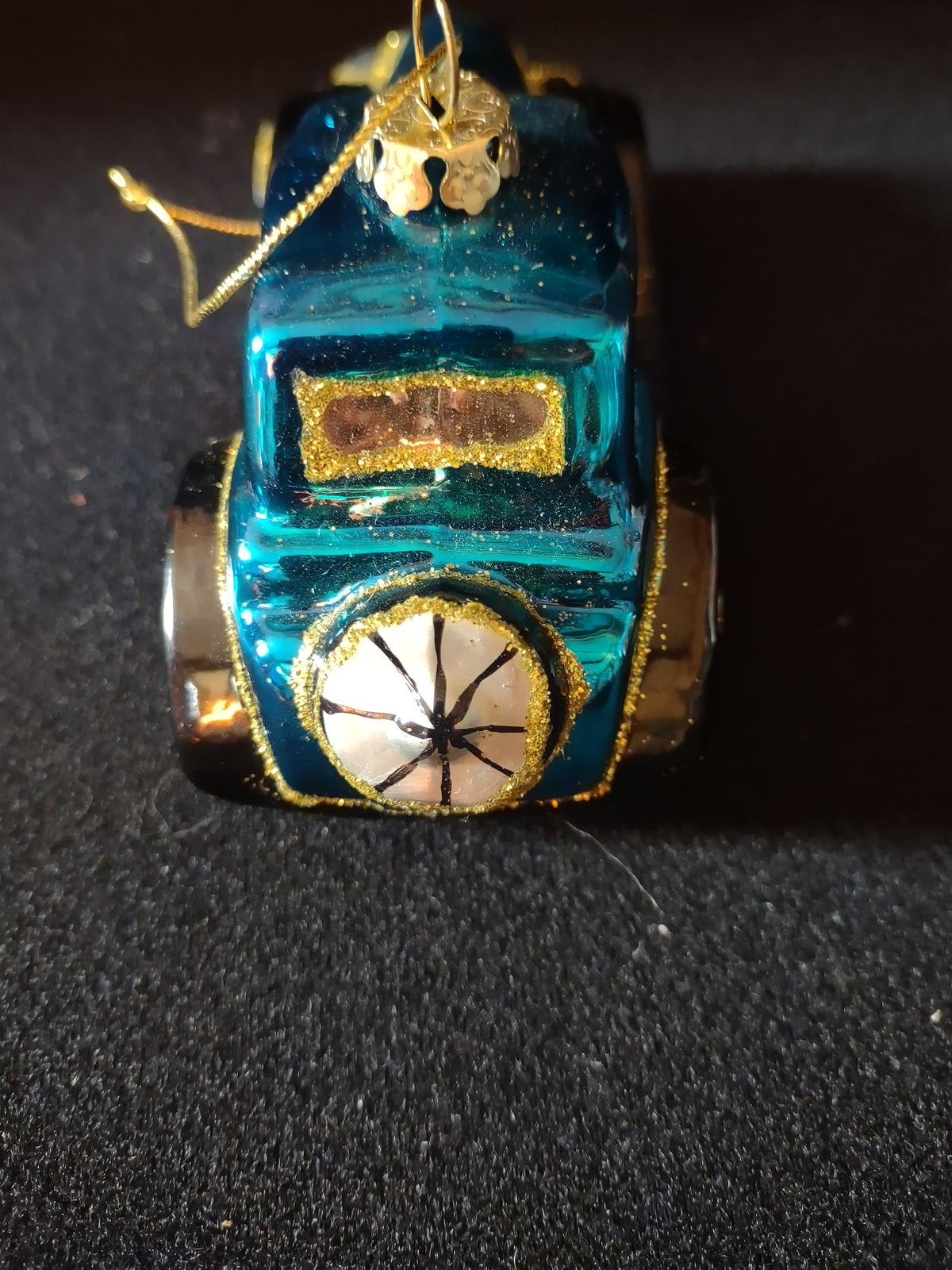 Rear view of turquoise glass car ornament showing spare tire