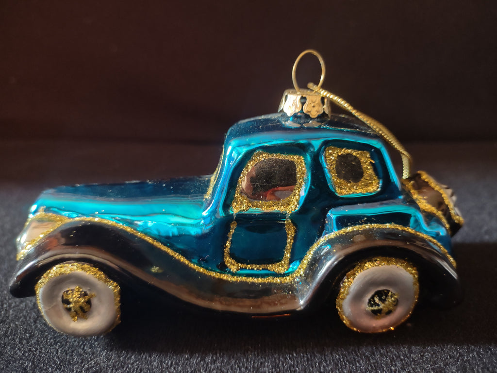 Turquoise antique-style glass car ornament with gold glitter and black fenders