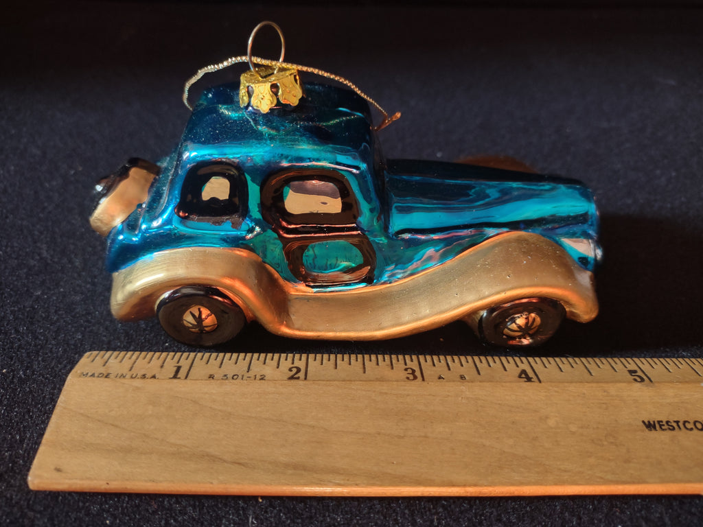 Car ornament beside ruler showing approximately 4.5 inch length