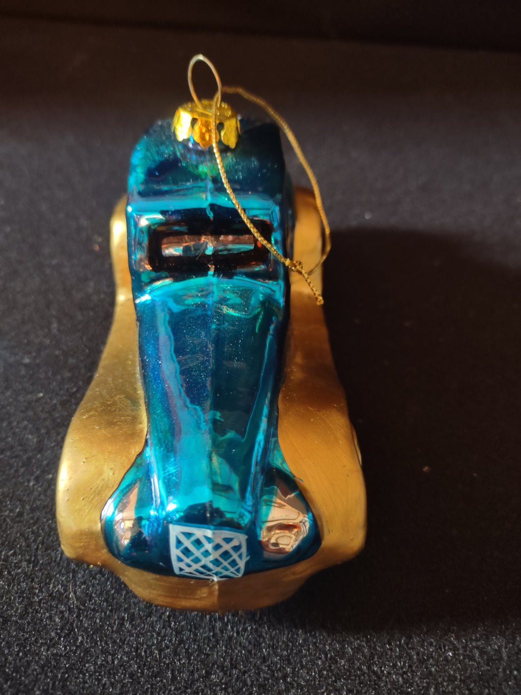 Front view of teal blue and gold car ornament