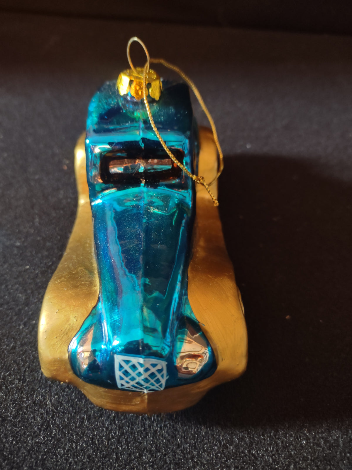Front view of teal blue and gold car ornament