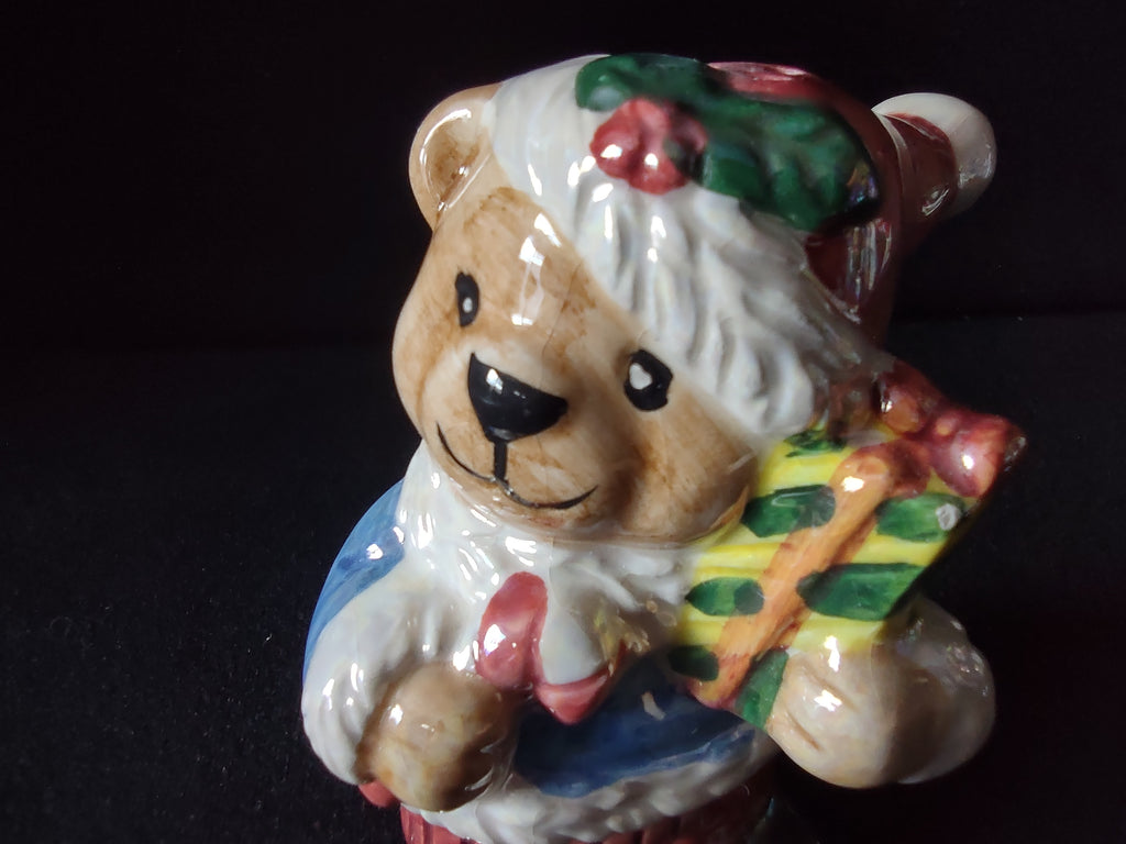 Teddy bear shaker holding a wrapped gift