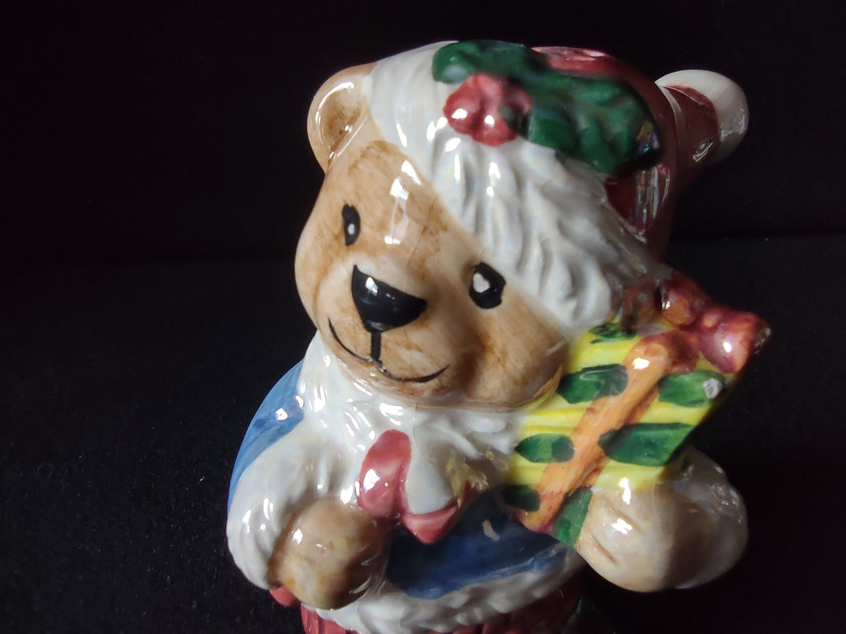 Teddy bear shaker holding a wrapped gift